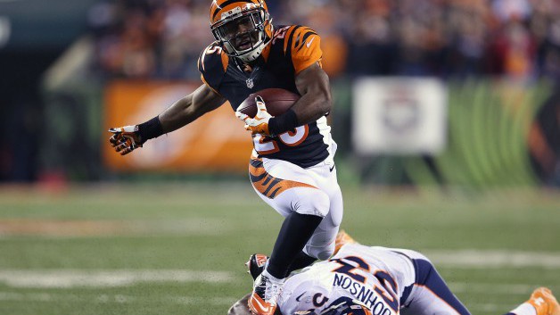 CINCINNATI OH- DECEMBER 22 Giovani Bernard #25 of the Cincinnati Bengals breaks a tackle by Steven Johnson #53 of the Denver Broncos to score a touchdown during the third quarter of the game at Paul Brown Stadium