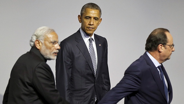 Lead on. U.S. President Barack Obama looks on as French host Francois Hollande leads Indian Prime Minister Narendra Modi off the stage at a clean energy symposium during the COP21 Paris talks