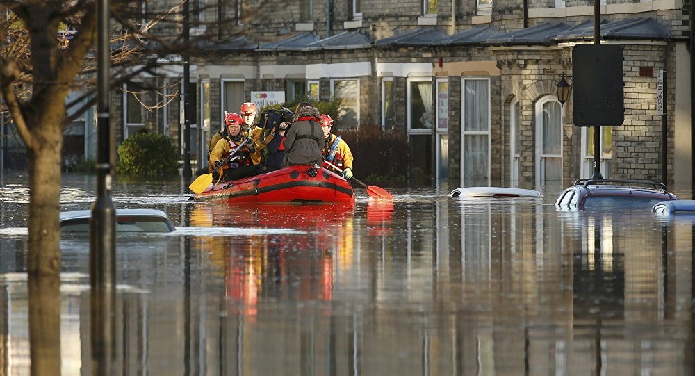 Emergency services navigate a flooded street in York northern England