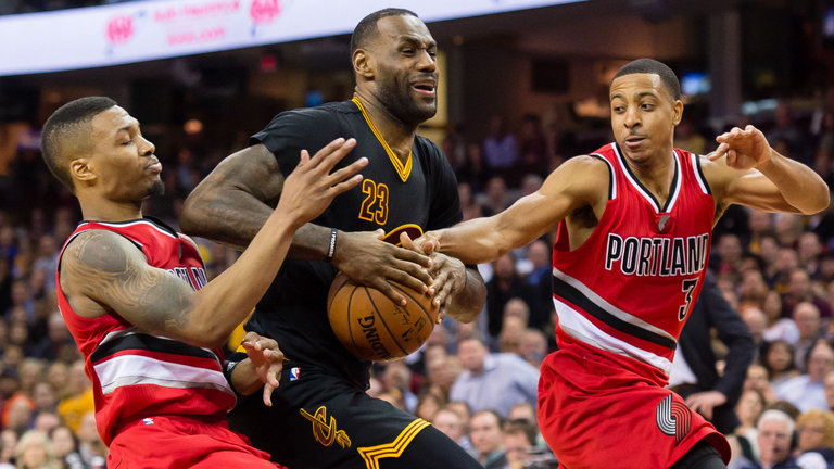 Damian Lillard and C.J. Mc Collum of the Portland Trail Blazers challenge Le Bron James of the Cleveland Cavaliers