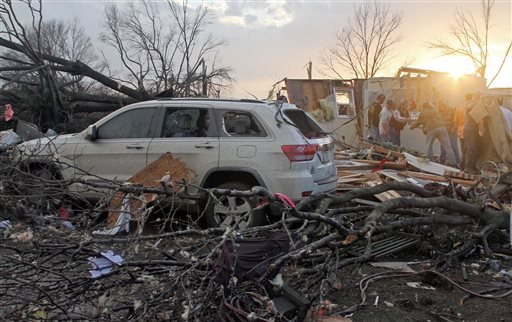 Neighbors help salvage items from a storm-damaged home in the Roundaway community near Clarksdale Miss. Wednesday Dec. 23 2015. A storm system forecasters called