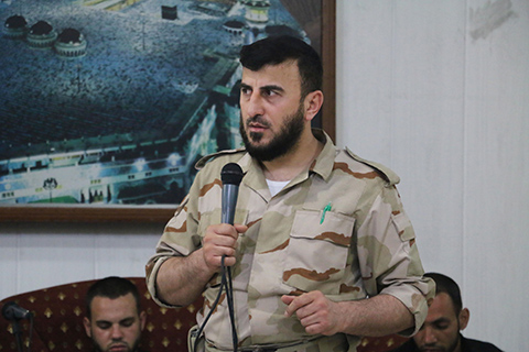 Zahran Alloush head of the Jaish al Islam Syrian rebel group speaks during the wedding of a fighter in the group