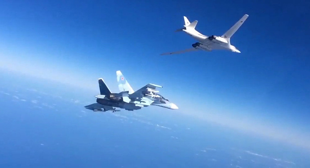 Russian Aerospace Defense Forces Su-30SM fighter escorts a Tu-160 bomber which fired cruise missiles at ISIS targets in Syria