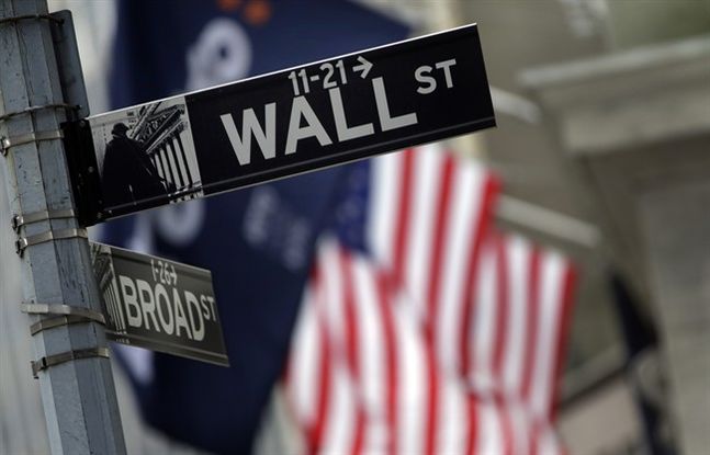 Street sign adjacent to the New York Stock Exchange in New York. European shares shed earlier gains Thursday Dec. 3 2015 after the European Central Bank failed to cut a key interest rate as much as many