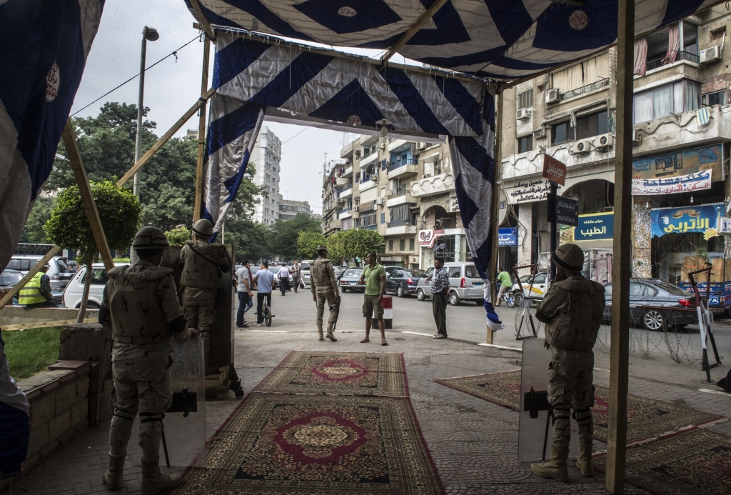 Egyptians soldiers stand guard outside a polling station in the Agouza neighbourhood of Cairo's Giza district on the second day voting in Egypt's parliamentary elections