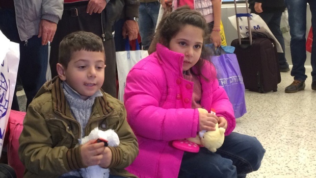 Two Syrian children wait for their flight from Beirut to Toronto. A Canadian Forces Airbus left Lebanon on Thursday with 163 of the 25,000 Syrian refugees the Liberal government plans to resettle across Canada by the end of February