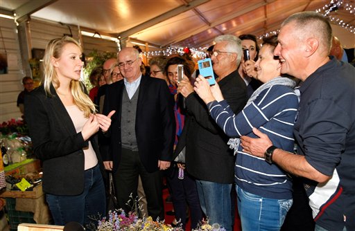 Far-right National Front party Marion Marechal Le Pen speaks with local residents as she campaigns for the upcoming regional elections in Cavaillon southern France Nov.11