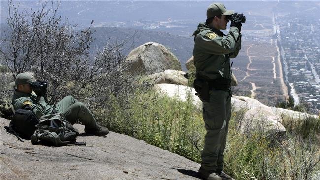 From Tecate Peak US Border Patrol officers look towards Mexico for signs of smugglers and illegal immigrants