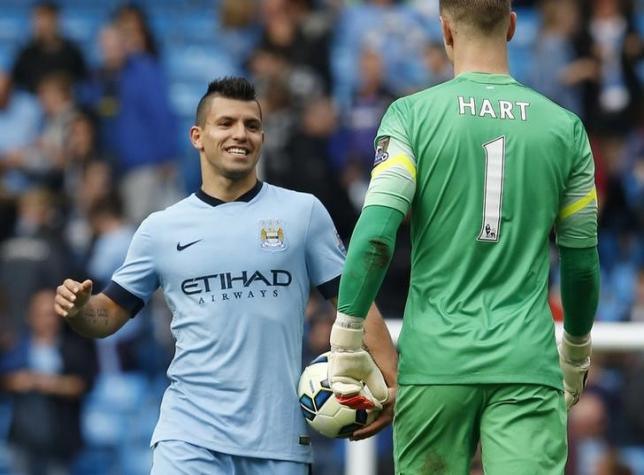 Manchester City's Sergio Aguero celebrates with goalkeeper Joe Hart after their English Premier League soccer match against Tottenham Hotspur at the Etihad Stadium in Manchester northern England