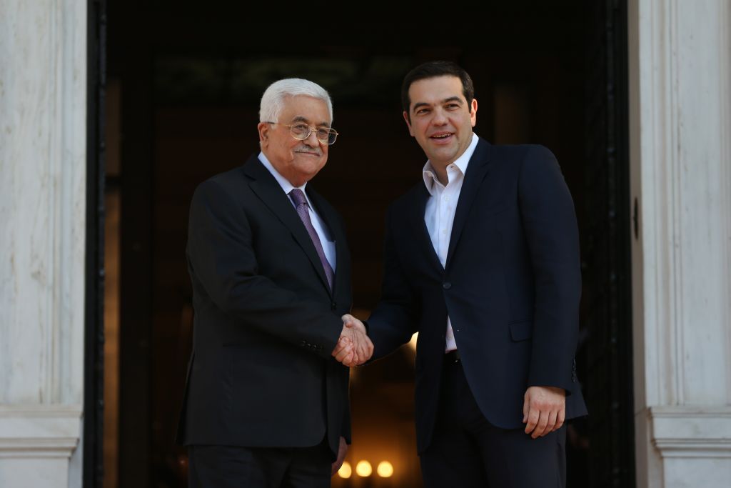 Greek Prime Minister Alexis Tsipras right shakes hands with President of the Palestinian Authority Mahmoud Abbas before their meeting in Athens