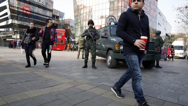 Heavily armed Chinese paramilitary police guard a popular mall in the Sanlitun district of Beijing China Thursday Dec. 24 2015