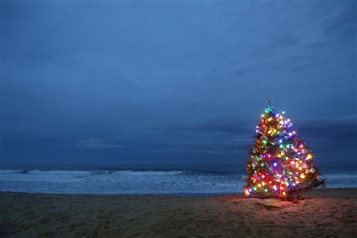 A beachside Christmas tree is lit on Thursday Dec. 24 2015 in Lavallette N.J. A weather pattern partly linked with El Nino has turned winter upside-down across the U.S. during a week of heavy holiday travel bringing spring-like warmth to the Northeas