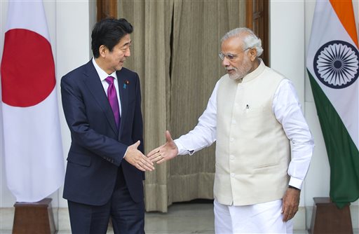 Indian Prime Minister Narendra Modi, and his Japanese counterpart Shinzo Abe are about to shake hands before their meeting in New Delhi India Saturday. Modi hopes the visit of Abe will be a major step in transforming India into an economic powe