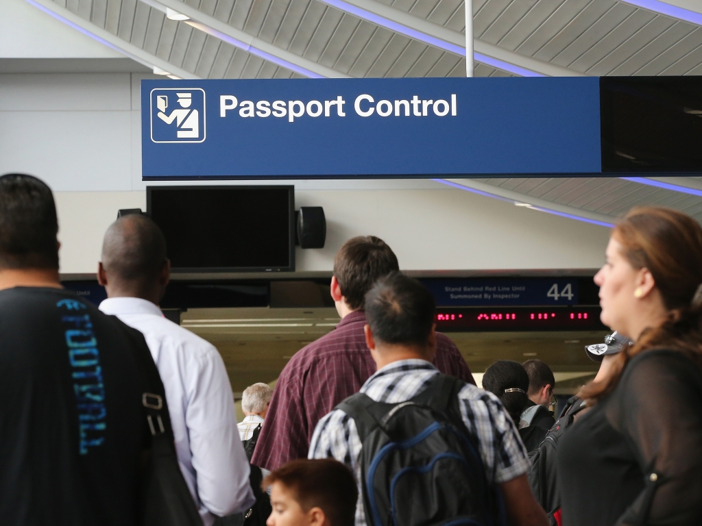 International travelers wait to have their passports checked at Chicago's O'Hare International Airport last year