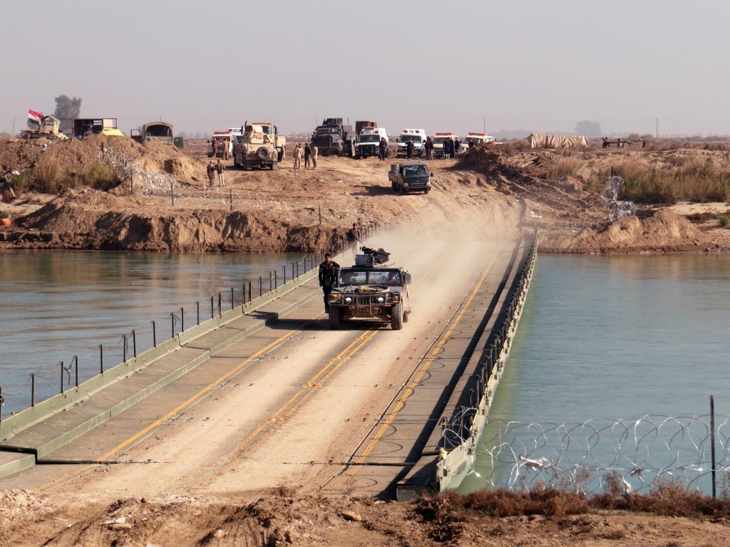 Iraqi government forces cross a bridge over the Euphrate river as they take position in al Aramil area south of Anbar province's capital Ramadi