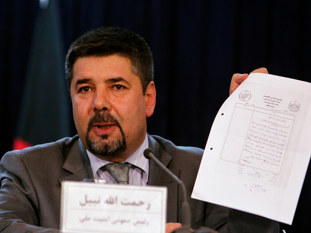 Rahmatullah Nabil head of Afghanistan's National Directorate Of Security, shows a paper during a joint news conference in Kabul