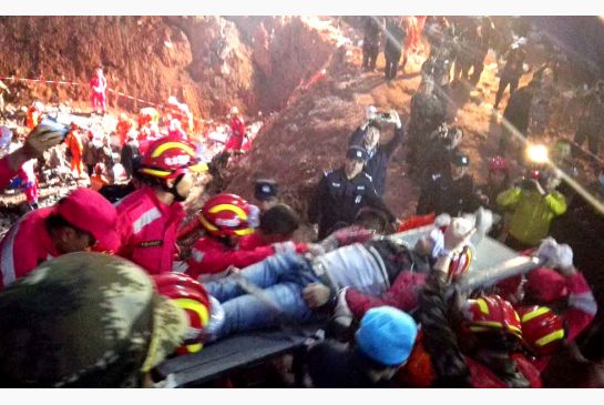 Rescuers carry 19-year-old survivor Tian Zeming after he was pulled from debris on Wednesday some 67 hours after a giant flow of mud and construction waste engulfed buildings in Shenzhen China