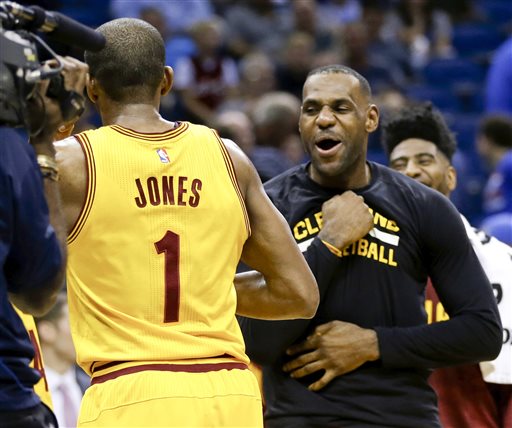 Cleveland Cavaliers forward Le Bron James right celebrates with guard James Jones after Jones made several 3-point shots in a row against the Orlando Magic during the second half of an NBA basketball game Friday Dec. 11 2015 in Orlando Fla. Clev