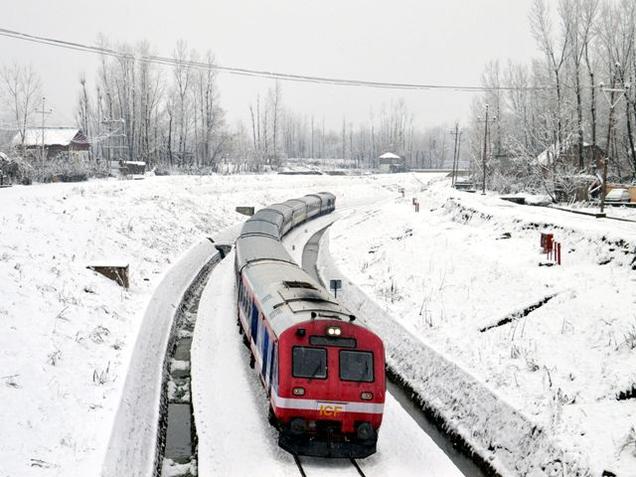 A train runs on snow-covered track at Qazigund in Jammu and Kashmir's Anantnag district