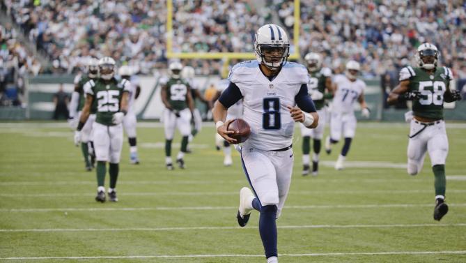 Tennessee Titans quarterback Marcus Mariota runs for a touchdown after he makes a catch during the second half of an NFL football game against the New York Jets Sunday Dec. 13 2015 in East Rutherford N.J