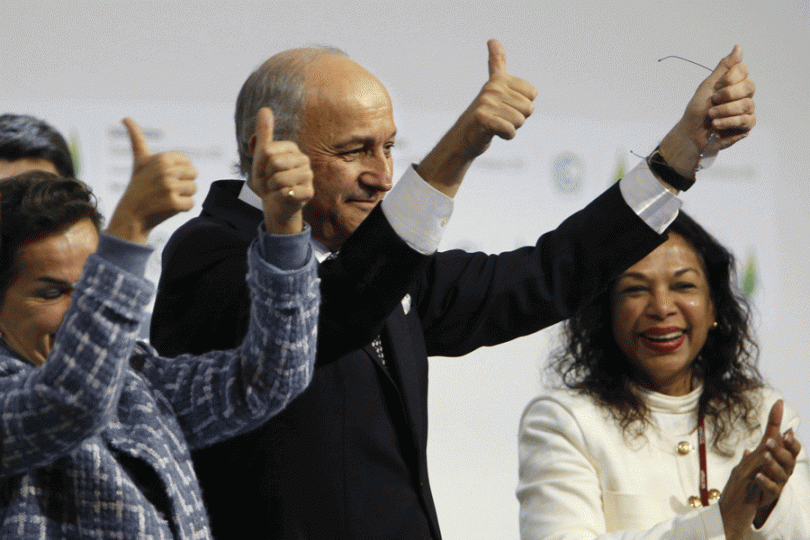 French Foreign Affairs Minister Laurent Fabius gestures after adoption of historic global warming pact