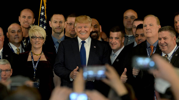 Donald Trump stands with law enforcement officers after receiving the endorsement of the New England Police Benevolent Association at the Sheraton Portsmouth Harborside Hotel