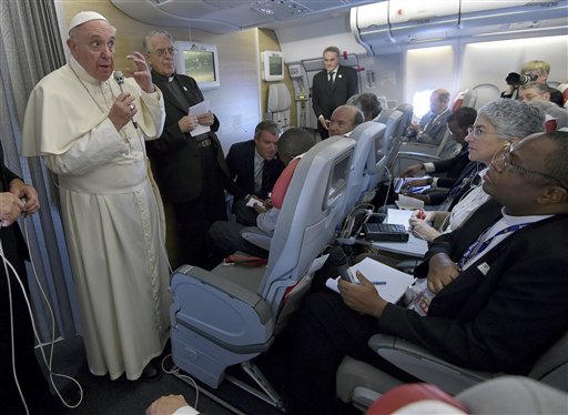 Pope Francis talks to journalists during a press conference he held aboard the flight on the way back to the Vatican Monday Nov. 30 2015. Pope Francis traveled to Africa for a six-day visit that took him to Kenya Uganda and the Central African Republi