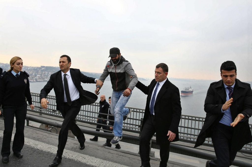 Presidential bodyguards escorting a man who was attempting suicide by jumping off the Bosphorus Bridge