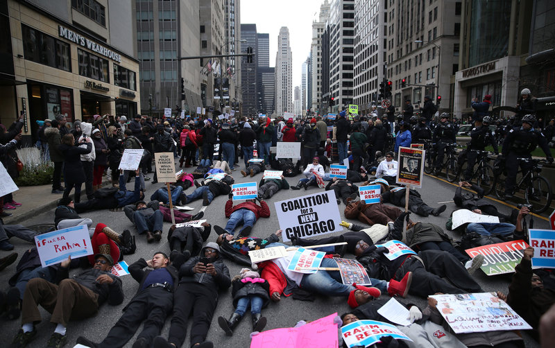 People participate in what organizers are calling a'Black Christmas protest on Michigan Avenue in downtown Chicago Thursday