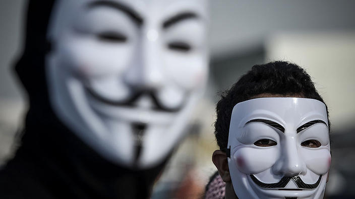 Protesters wearing Guy Fawkes masks used by the Anonymous movement 
     
    
                   
     
     
           Sho