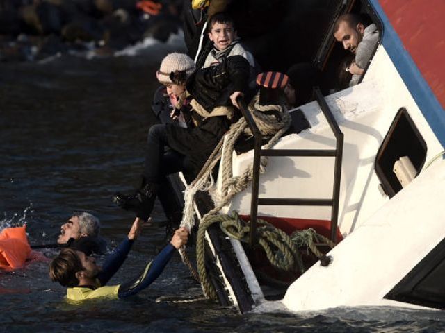 A young boy cries out for help with other refugees and migrants as their boat sinks off the Greek island of Lesbos island while crossing the Aegean sea from Turkey