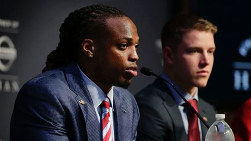 Alabama's Derrick Henry left answers questions for the media as Stanford's Christian Mc Caffrey looks on before the start of the Heisman Trophy award presentation show Saturday Dec. 12 2015 in New York