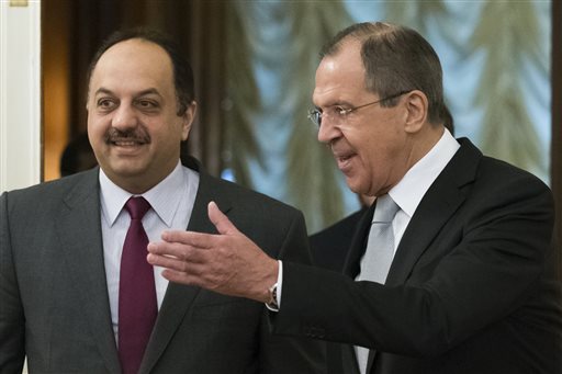 Russian Foreign Minister Sergey Lavrov right greets Qatari Foreign Minister Khalid bin Mohammad al Attiyah as they enter a hall for their talks in Moscow Russia Friday Dec. 25 2015. Lavrov and al Attiyah are expected to discuss bilateral issues