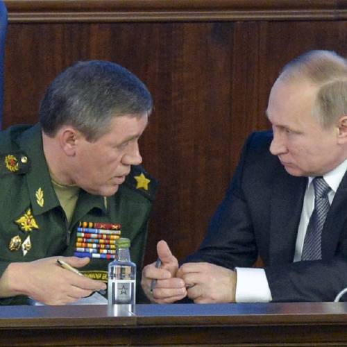 Vladimir Putin right speaks with Chief of the General Staff of the Russian Armed Forces Valery Gerasimov at a meeting with top military officials in the National Defense Control Center in Moscow Russia Friday Dec. 11 2015