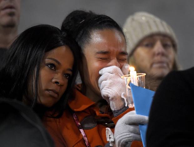 A woman cries during a candlelight vigil for shooting victims on Thursday Dec. 3 2015 at San Manuel Stadium in San Bernardino Calif. A husband and wife opened fire on a holiday banquet killing multiple people on Wednesday. Hours later the couple die