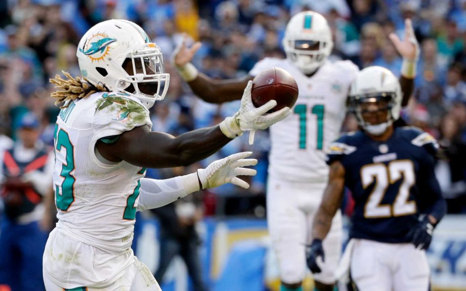 Miami Dolphins running back Jay Ajayi left celebrates after scoring during the second half in an NFL football game against the San Diego Chargers Sunday Dec. 20 2015 in San Diego