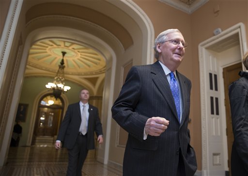 Senate Majority Leader Mitch McConnell R-Ky. walks from the chamber as Republicans pushed legislation toward Senate approval that would demolish President Barack Obama's signature health care law and halt Planned Parenthood's federal money setting up