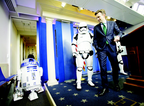 White House Press secretary Josh Earnest is joined by Star Wars Stormtroopers and R2 D2 in the Brady Press Briefing Room of the White House on Dec 18