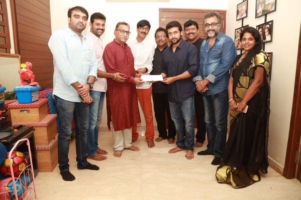 Suriya handling the cheque to the Nadigar Sangam President Nasser