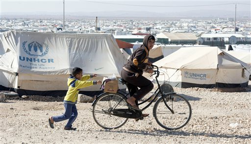 Young Syrian refugees play in the Zaatari Refugee Camp near the city of Mafraq Jordan Sunday Nov. 29 2015