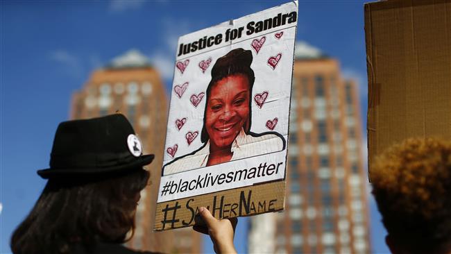 A woman holds a poster bearing the portrait of Sandra Bland a 28-year-old black woman who killed herself in a Texas jail cell on July 13th  during a Michael Brown memorial rally on Union Square