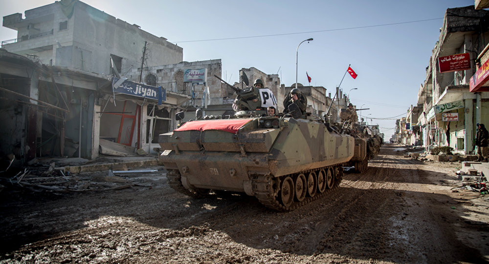 Turkish army's armored vehicles and tanks drive in Syrian town of Ayn al-Arab also known as Kobani as they return from the Ottoman tomb in Syria Sunday Feb. 22 2015