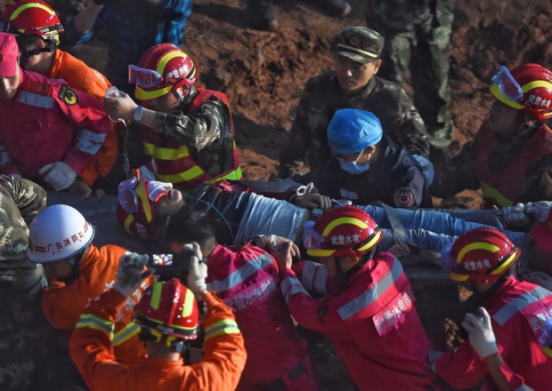 Tian Zeming is carried away from the landslide in an industrial park in Shenzhen