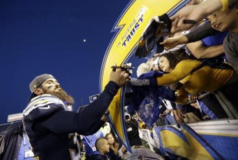 San Diego Chargers free safety Eric Weddle signs autographs after their win against the Miami Dolphins during the second half in an NFL football game Sunday Dec. 20 2015 in San Diego