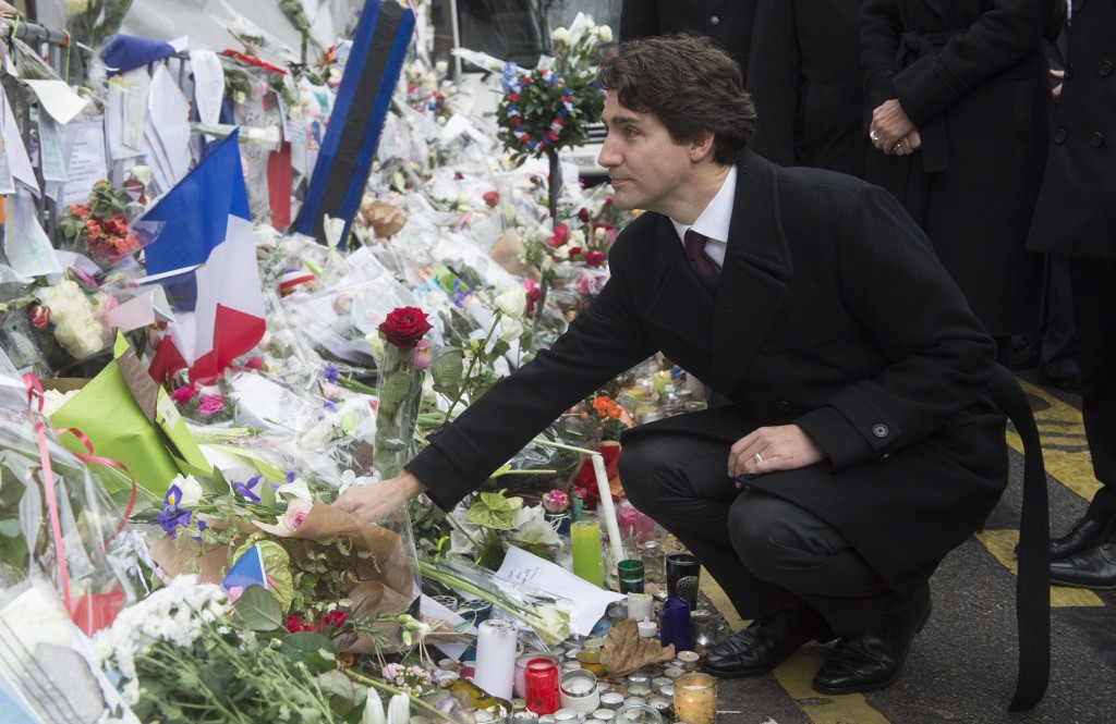 Canadian Prime Minister Justin Trudeau lays a flower at a memorial outside the Bataclan Cafe in Paris France on Sunday Nov. 29 2015