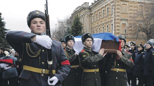 Servicemen carry the coffin during a mourning procession before the funeral of Alexander Pozynich a Russian marine killed during an operation to recover the crew of the downed Su-24 jet in Novocherkassk Rostov region Russia