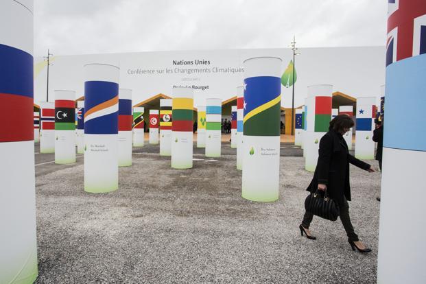 National flags sit on columns outside the United Nations COP21 climate summit at Le Bourget in Paris France