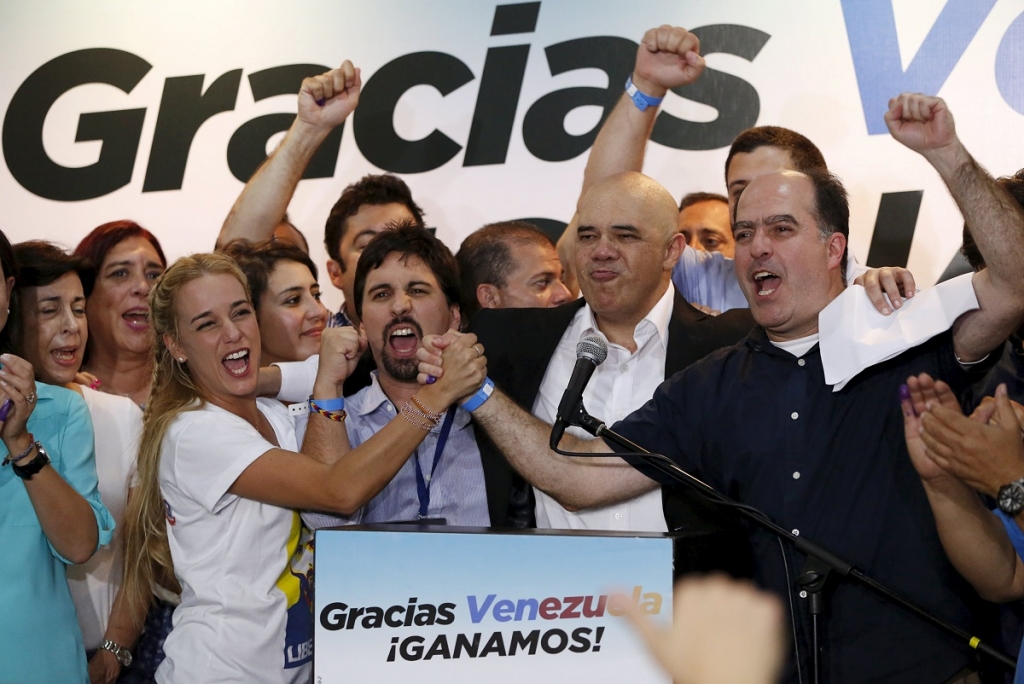 Lilian Tintori, wife of jailed Venezuelan opposition leader Leopoldo Lopez celebrates next to candidates of the Venezuelan coalition of opposition parties during a news conference on the election in Caracas early today. – Reuters