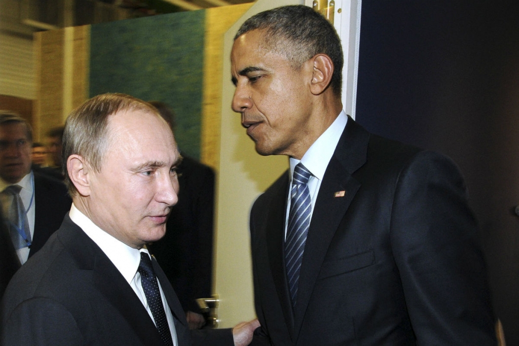 Vladimir Putin shakes hands with Barack Obama during the World Climate Change Conference 2015 in Paris