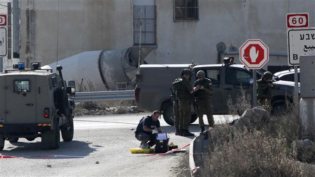 Israeli forces inspect the scene where a Palestinian was shot dead after he allegedly tried to stab Israelis with a screwdriver south of the West Bank city of al Khalil